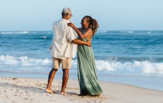 older couple dancing on the beach after recovering from evlt for varicose veins