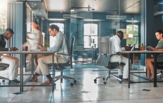 employees sitting at desks in a corporate office